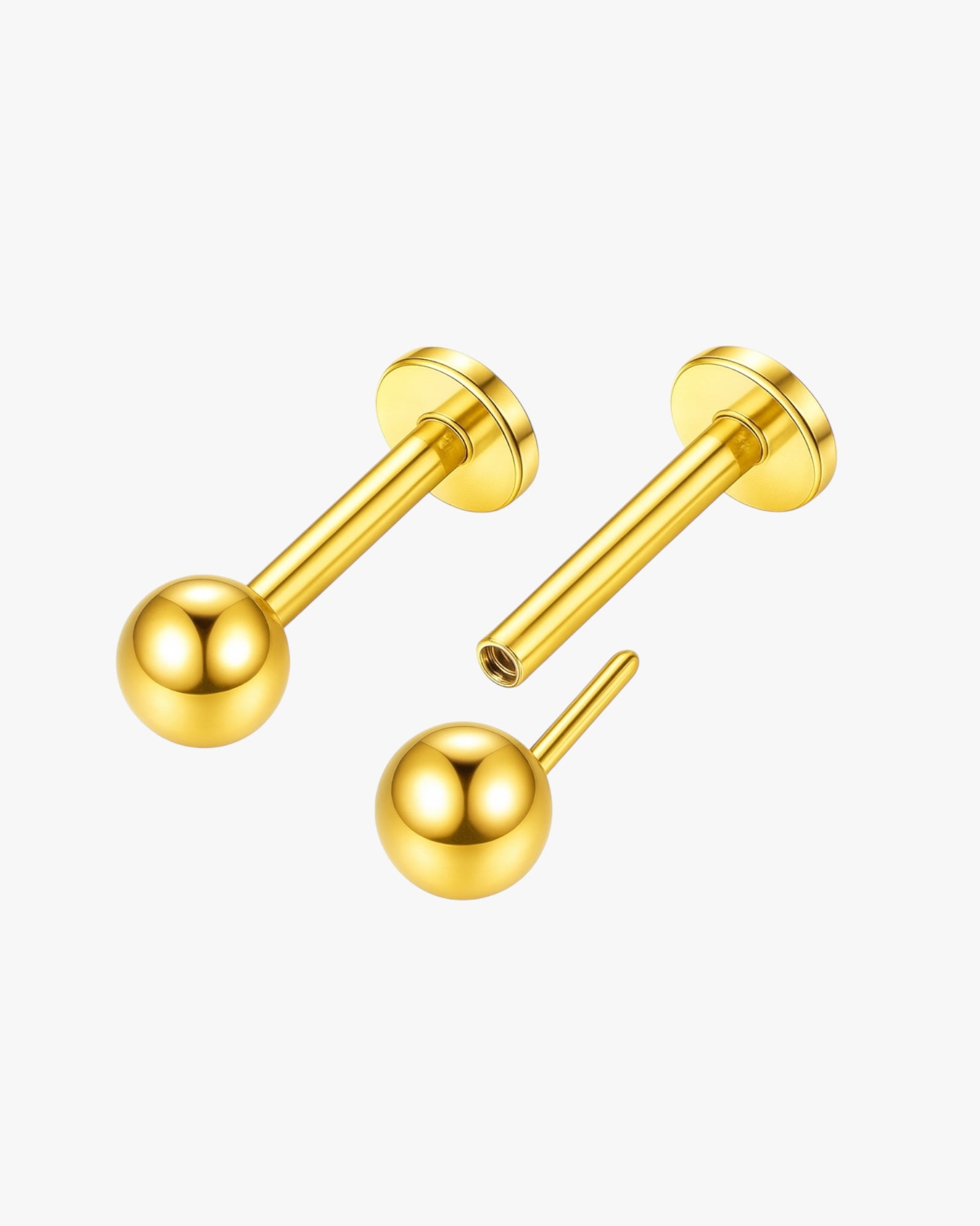 Gold barbell earrings on a white background
