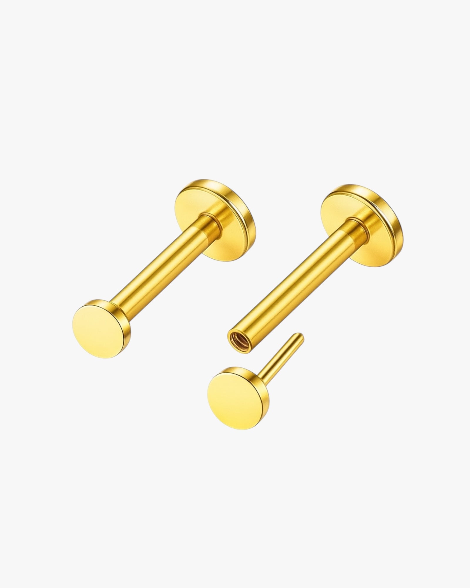 Pair of gold stud earrings on a white background