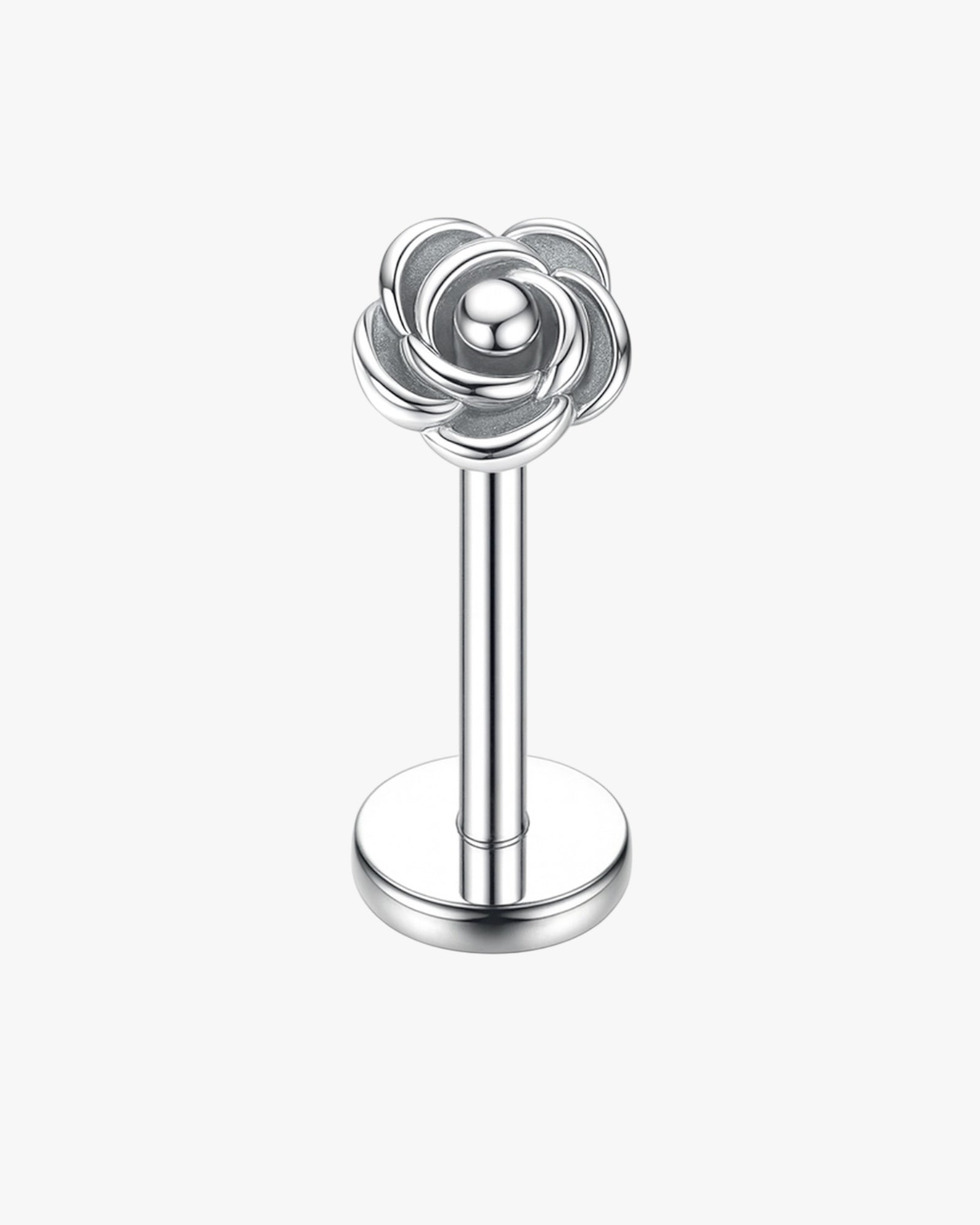 Silver rose-shaped earring on a white background