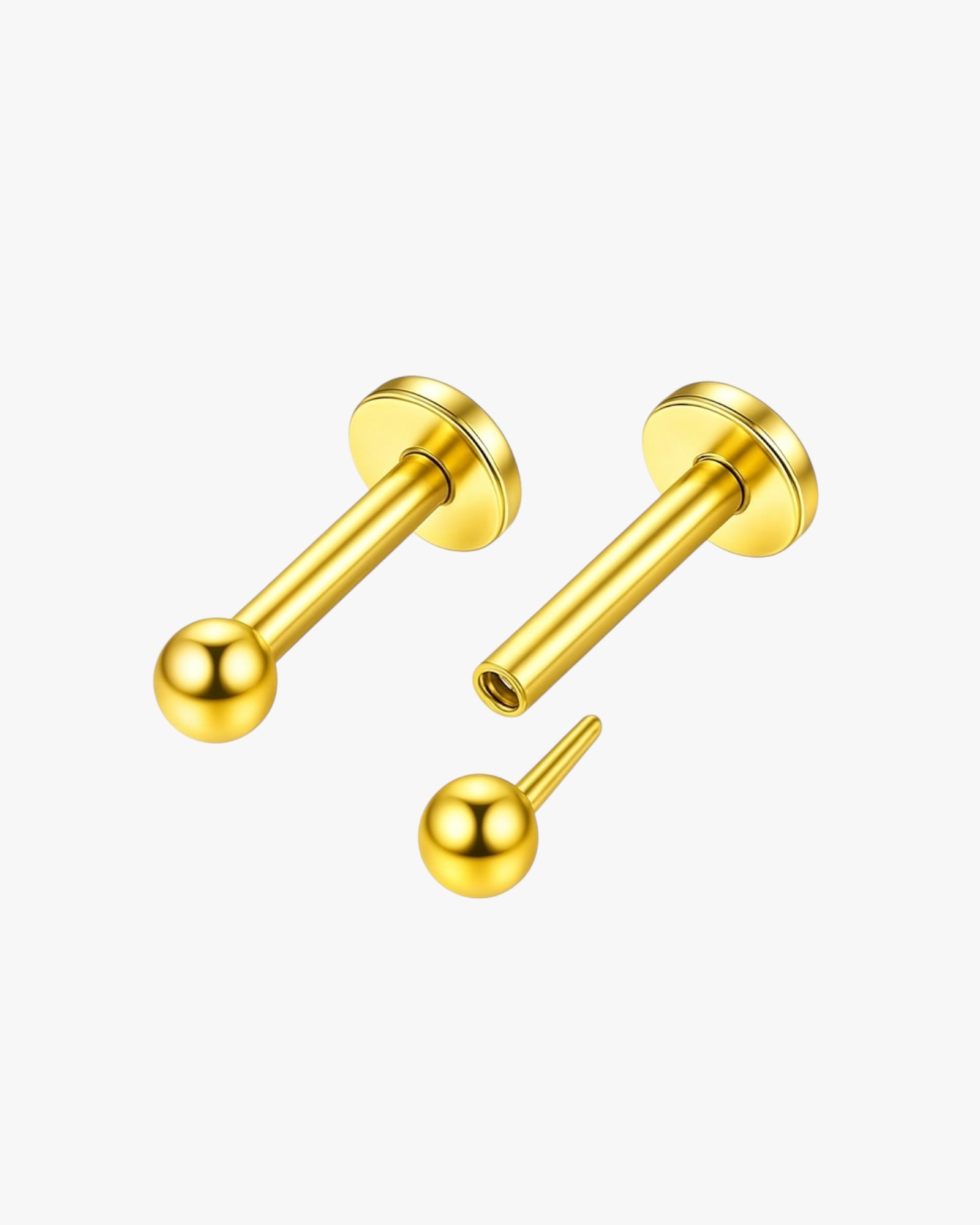 Gold push in earring set on a white background