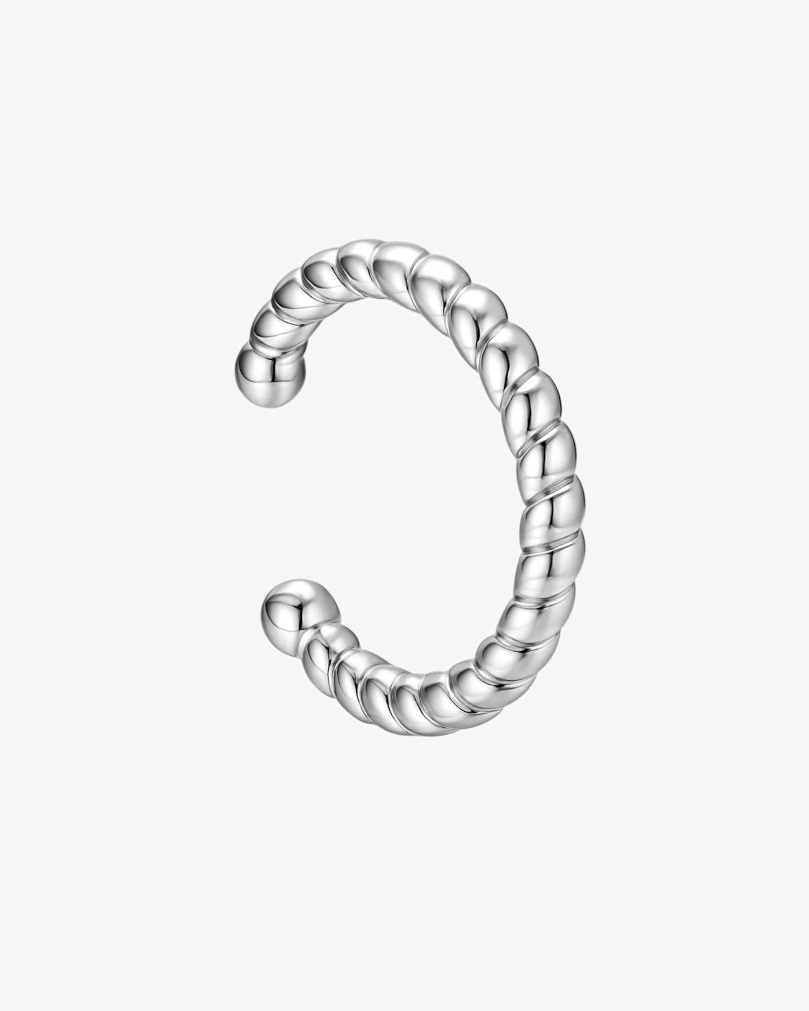 Silver twisted ear cuff on a white background