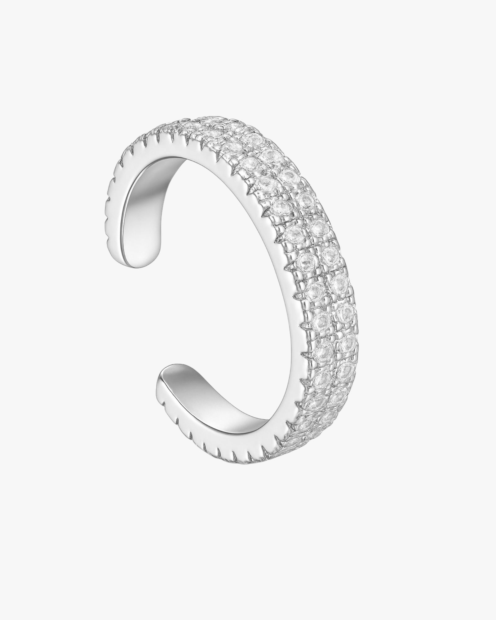 Silver ear cuff with clear gemstones on a white background