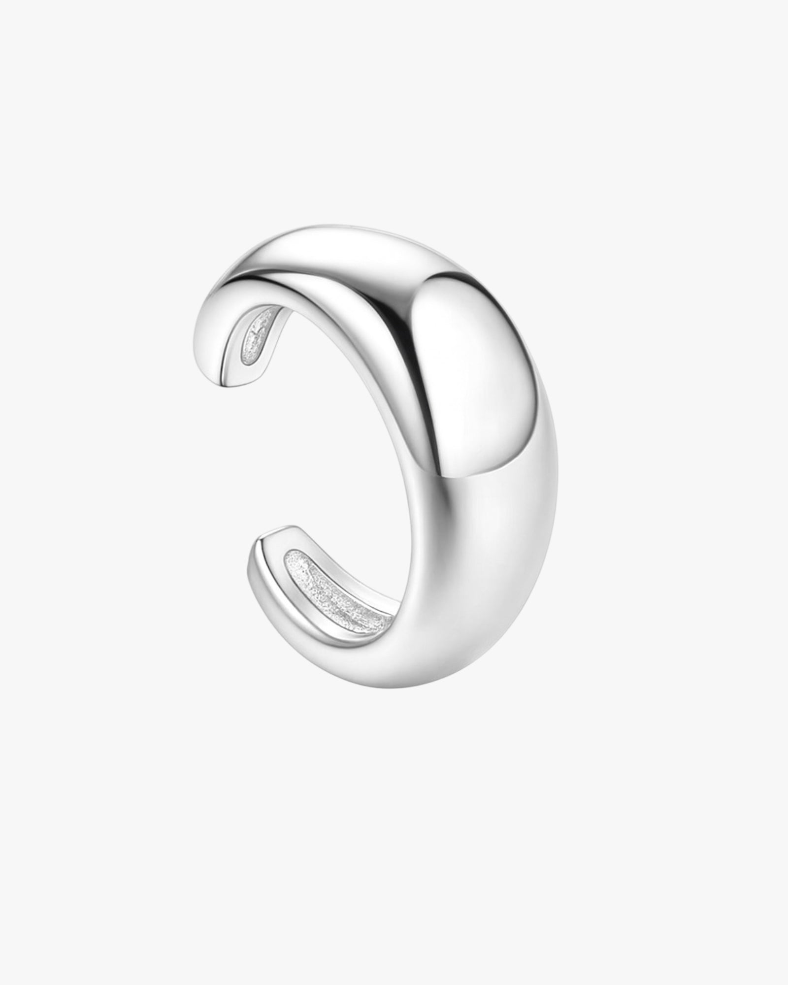 Silver eaar cuff with a curved design on a white background
