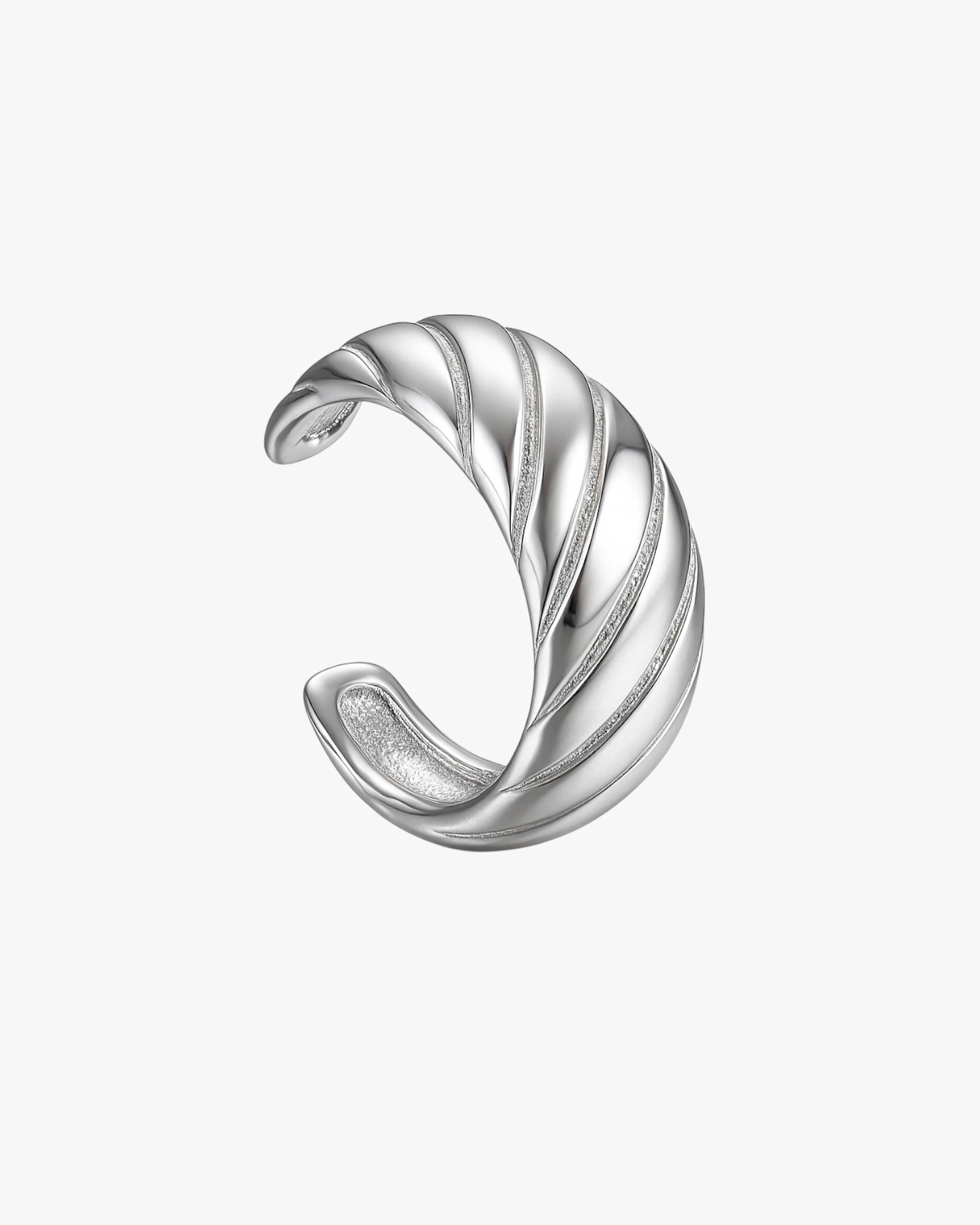 Silver ear cuff with a wavy design on a white background