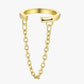 Gold ear cuff with a chain extension on a white background