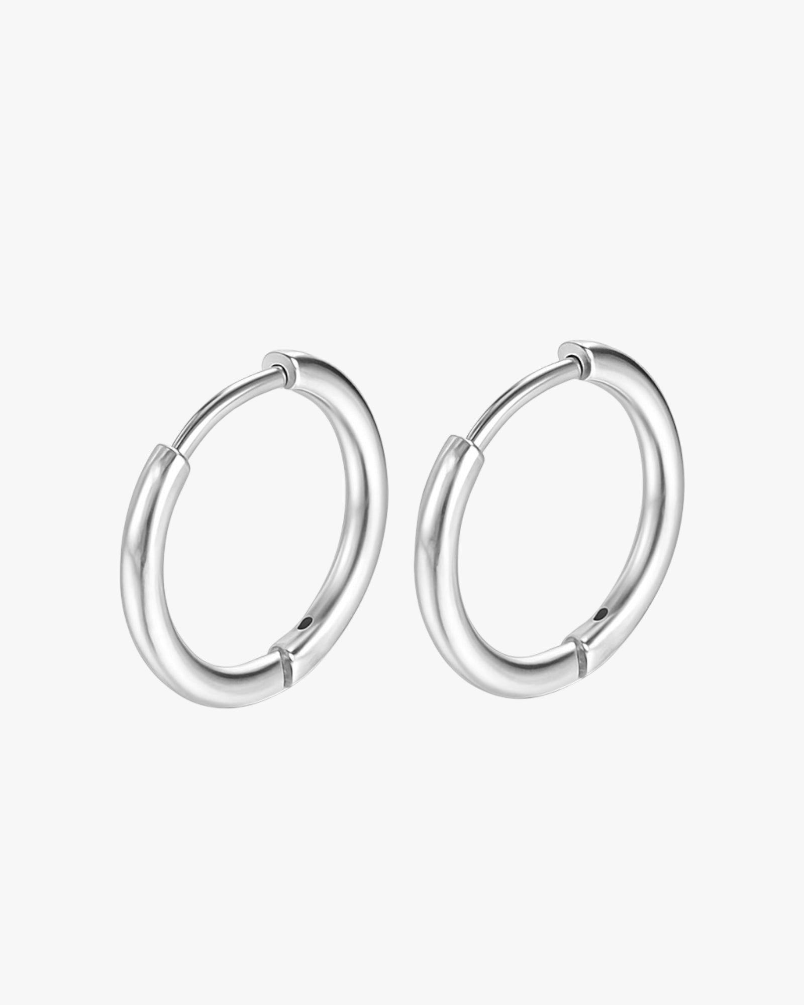 Pair of silver hoop earrings on a white background