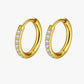 Gold hoop earrings with embedded stones on a white background