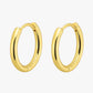 Gold hoop earrings on a white background