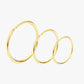 Gold hoop earrings on a light gray background