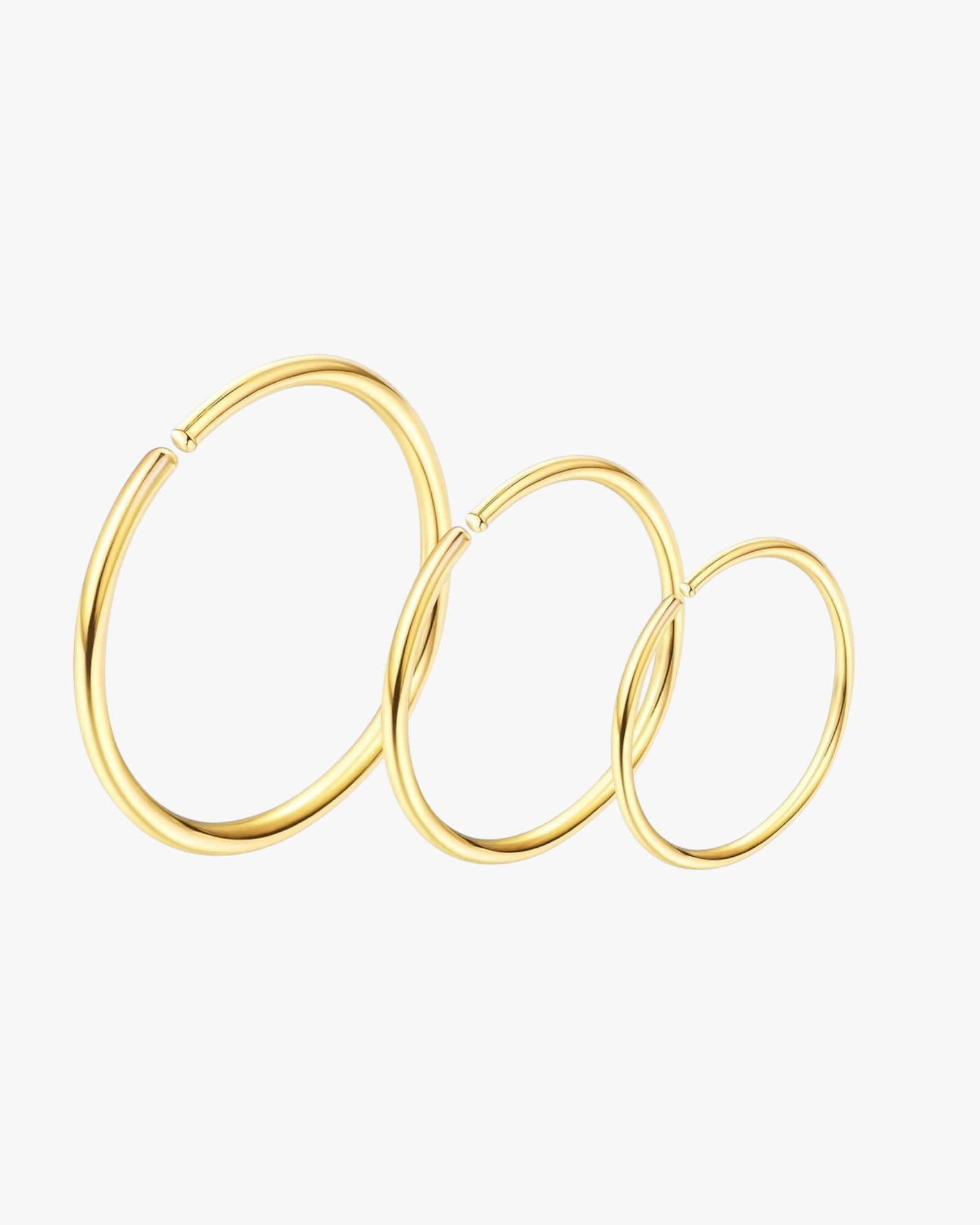 Gold hoop earrings on a light gray background
