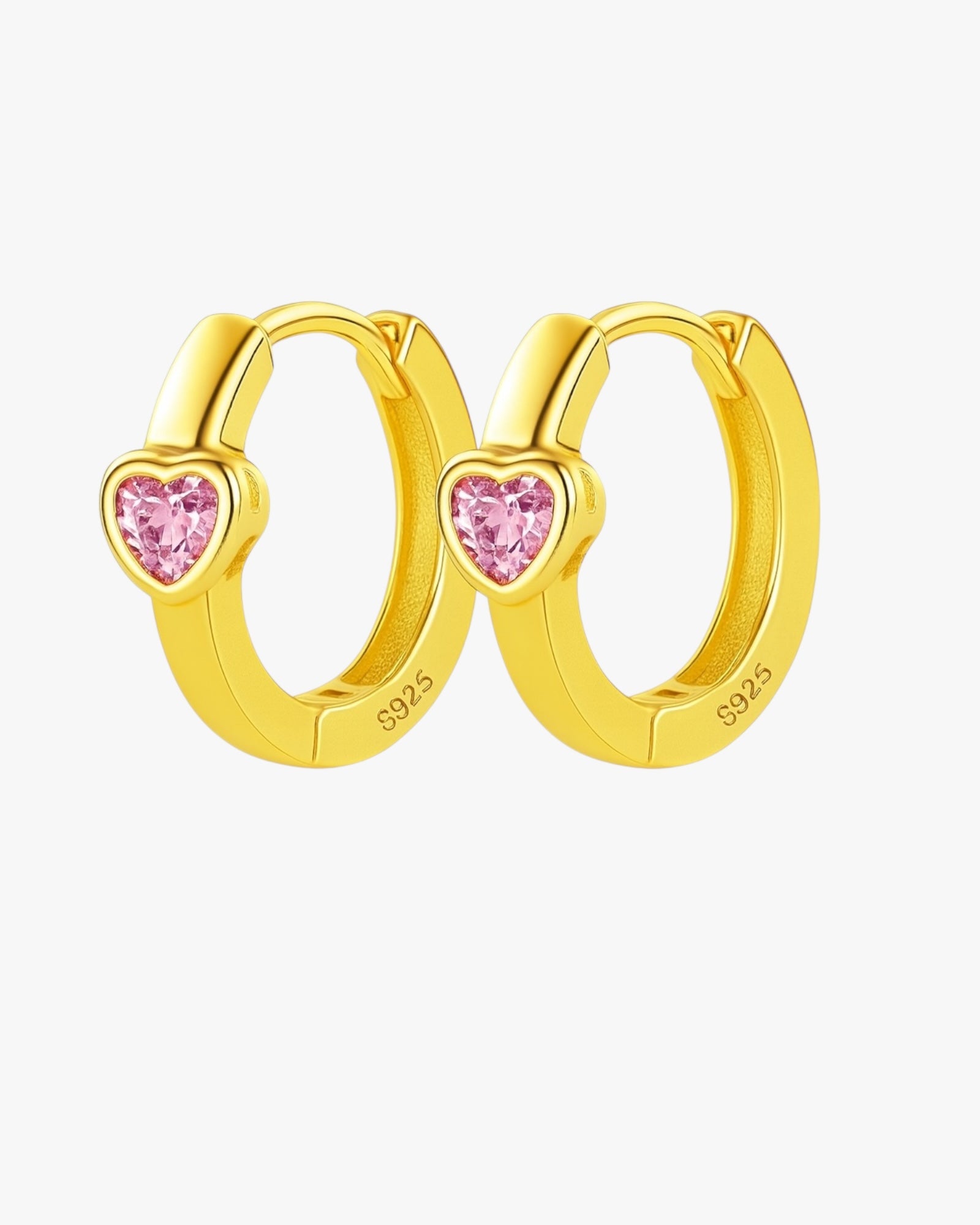 Gold heart-shaped hoop earrings with pink gemstones on a white background