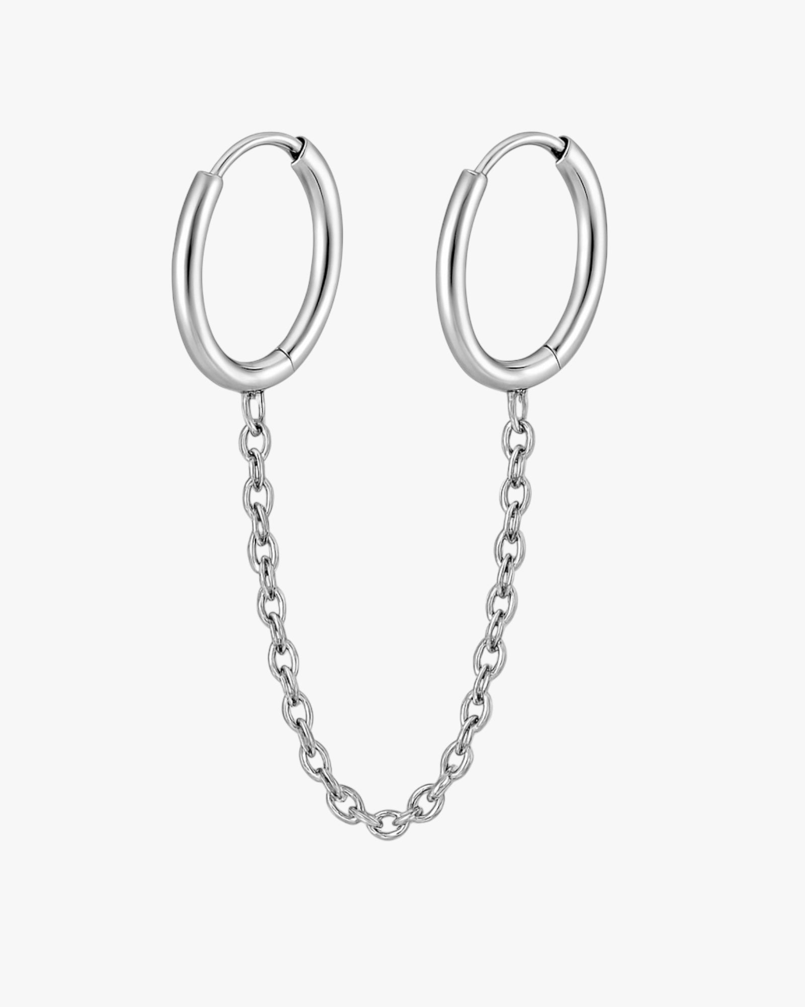 Silver hoop earrings with a chain on a white background