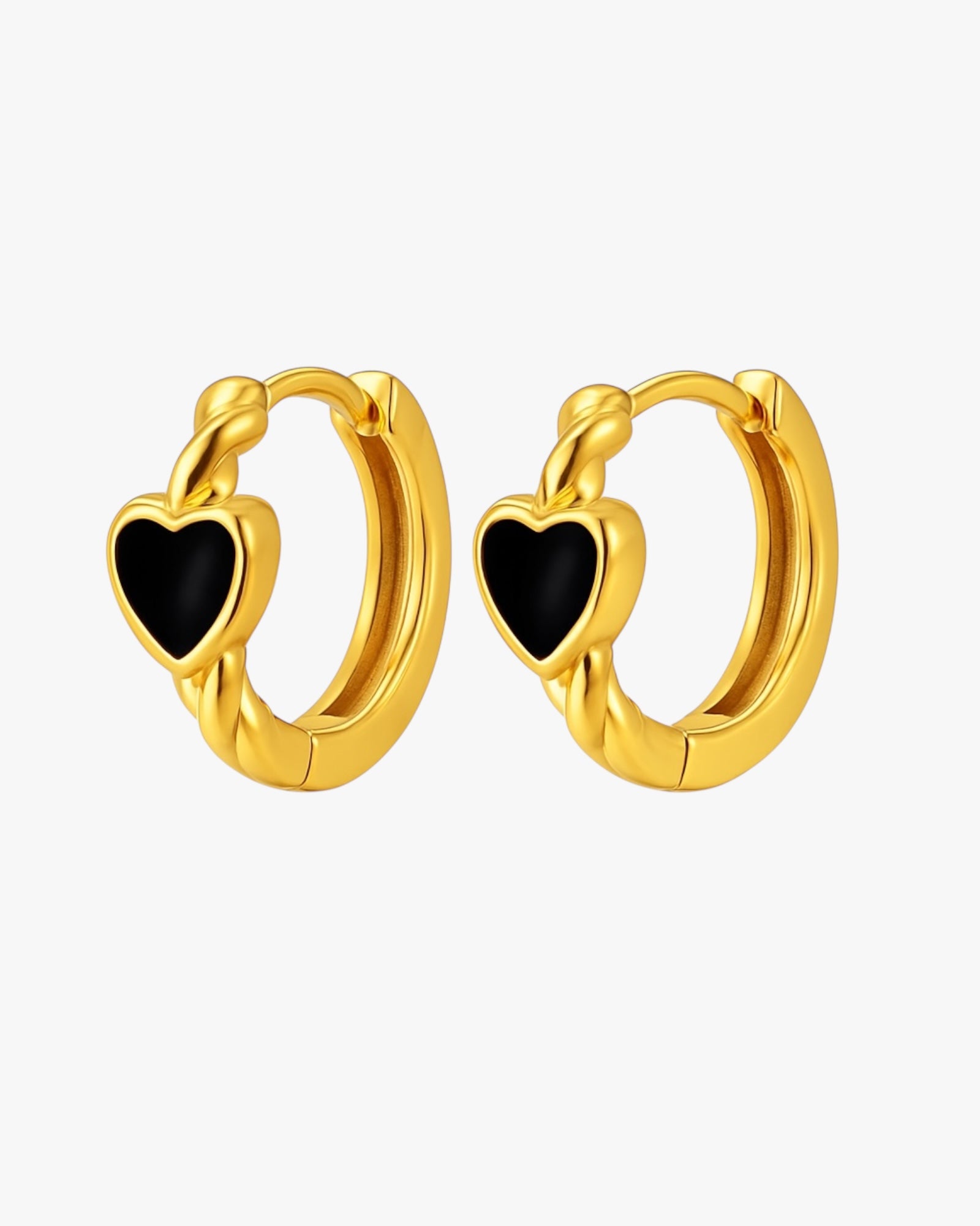 Gold hoop earrings with black heart stones on a white background