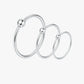 Set of silver hoop earrings on a white background