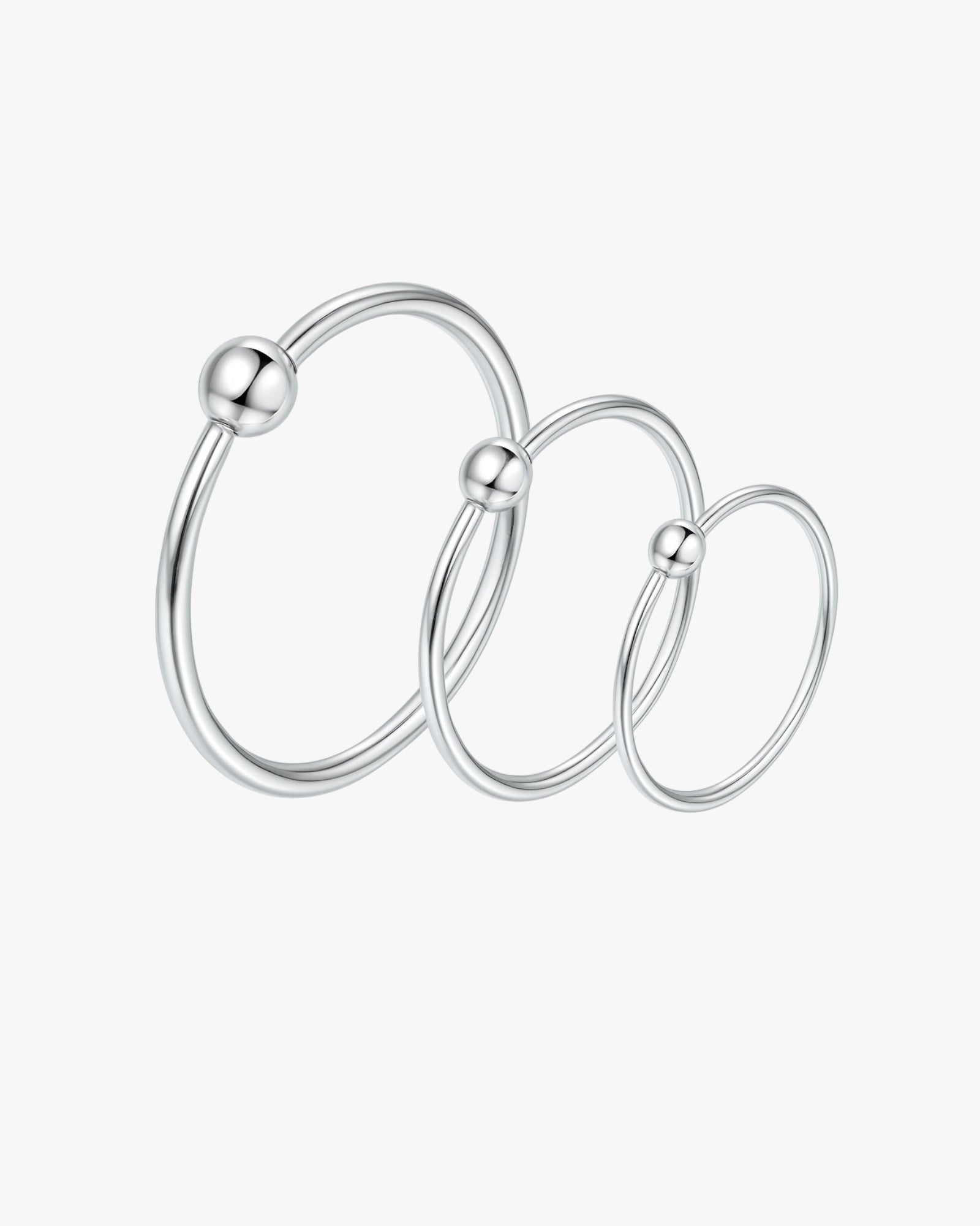 Set of silver hoop earrings on a white background