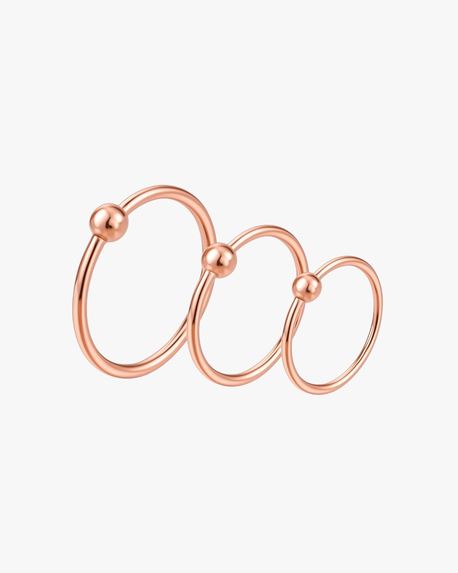 Rose gold hoop earring on a white background