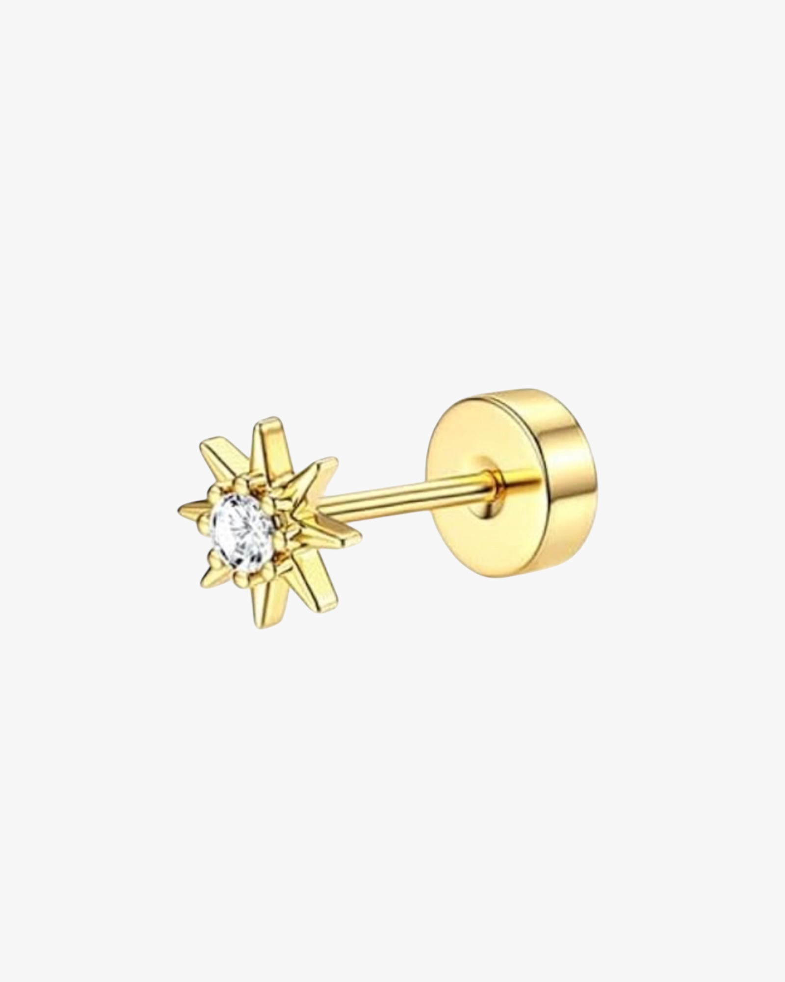 A single gold-colored stud earring with a star shape and a small clear stone at the top.