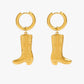 Gold hoop earrings with cowboy boot charms on a white background