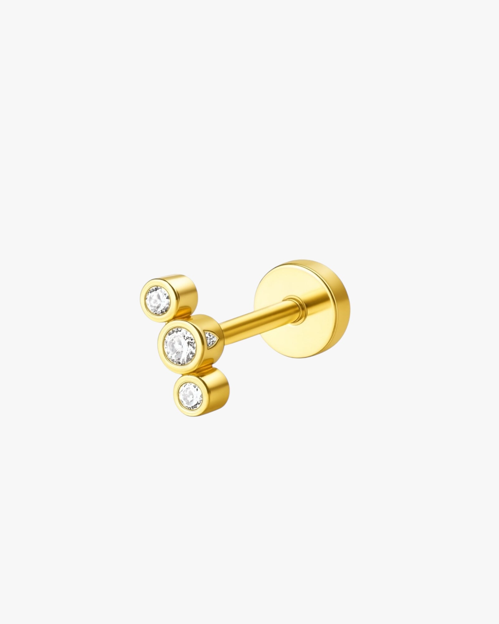 Gold stud earring with three clear gemstones on a white background