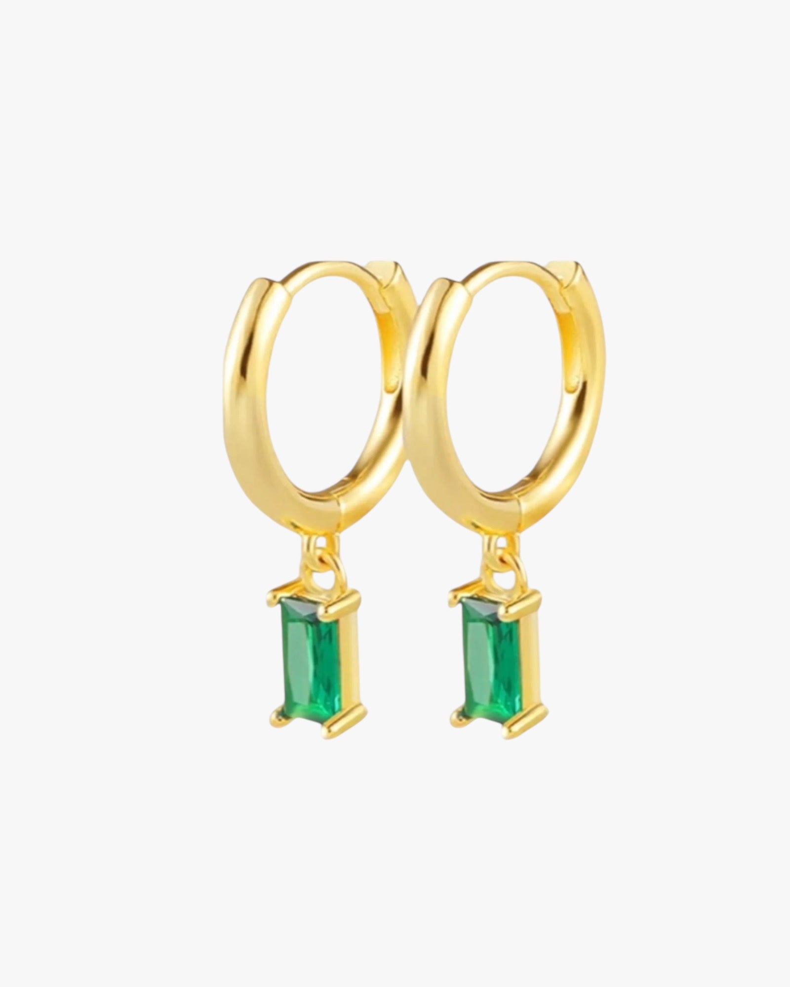A pair of gold-plated emerald hoop earrings with a solid brass construction, featuring a 14K gold plating and emerald accents.