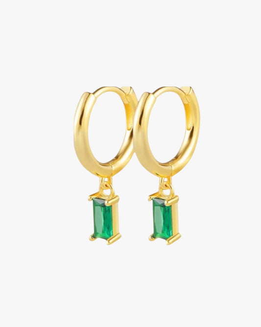 A pair of gold-plated emerald hoop earrings with a solid brass construction, featuring a 14K gold plating and emerald accents.
