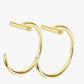 A pair of gold-colored stainless steel hoop earrings with a sleek finish.