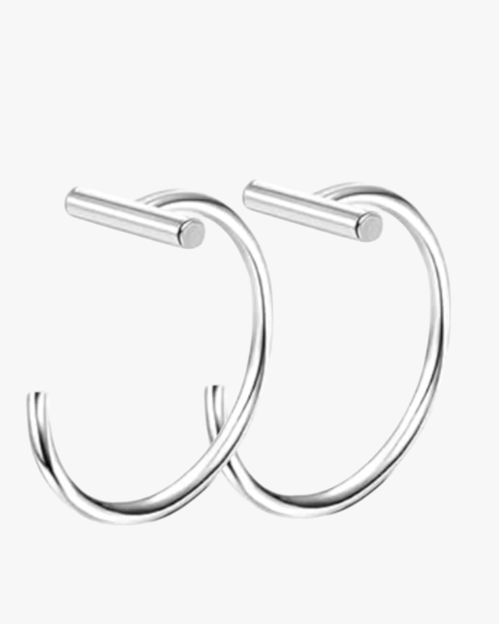 A silver colored stainless steel hoop earrings with a sleek finish.