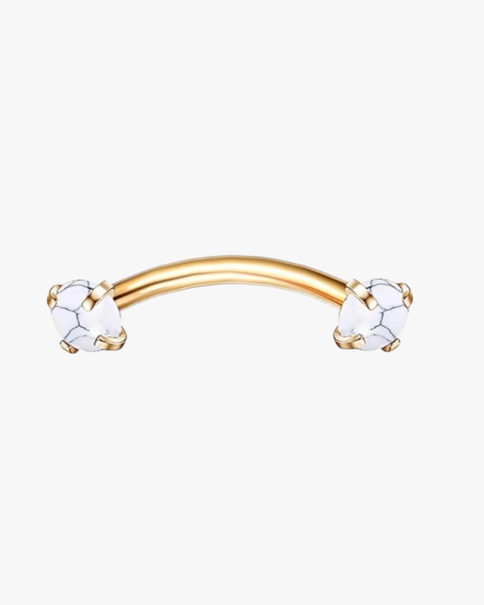 A gold-colored curved barbell with clear crystal embellishments on the bar.
