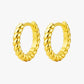 Pair of gold hoop earrings on a white background