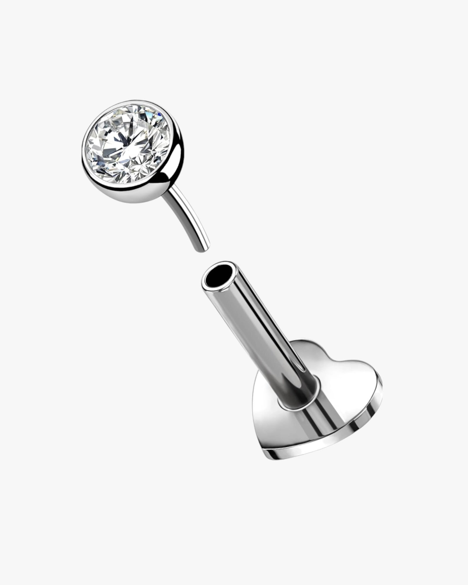 A double-headed stud earring with a heart-shaped design, featuring a clear, multicolored gemstone in the center.