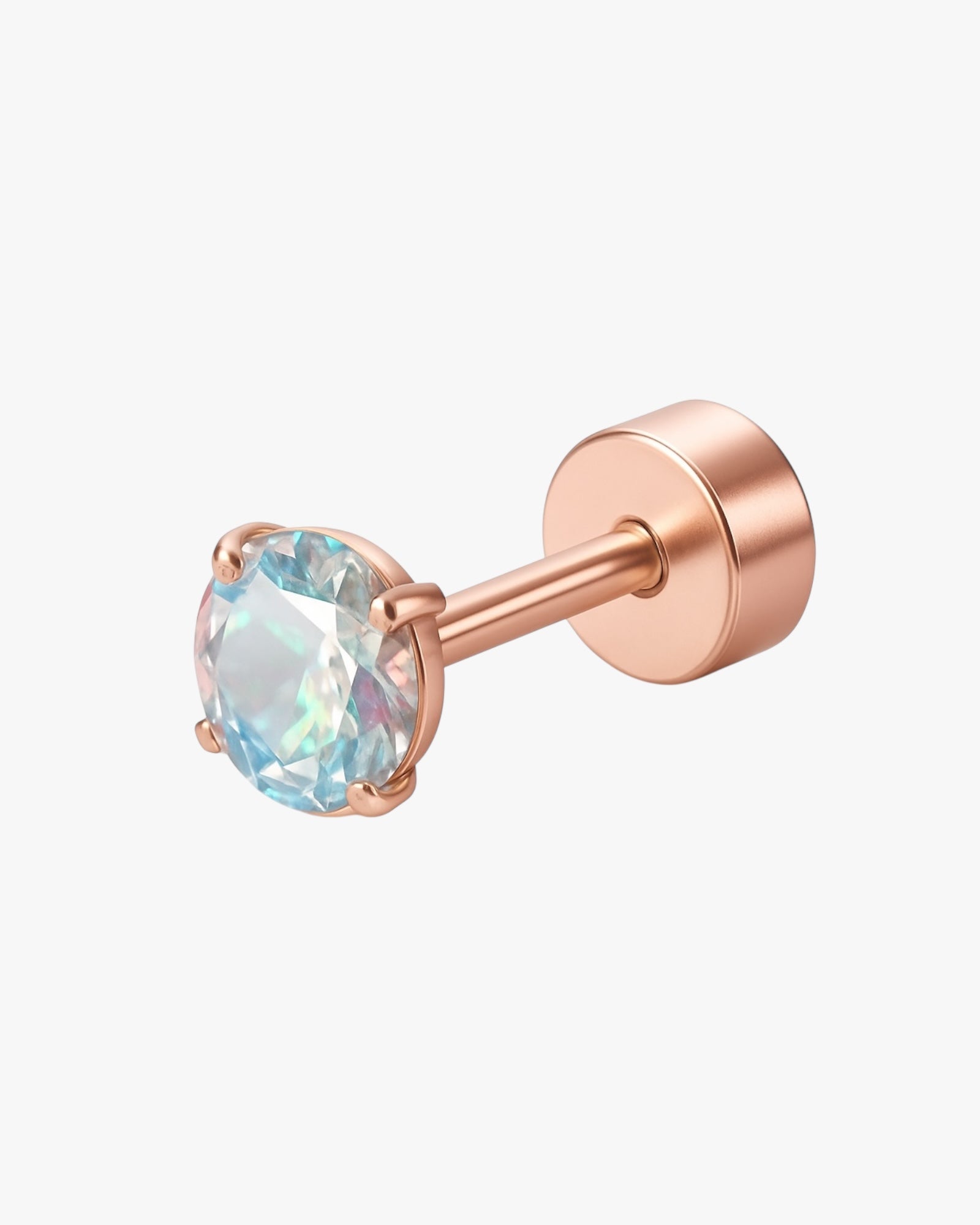 Rose gold stud earring with a clear gemstone on a white background