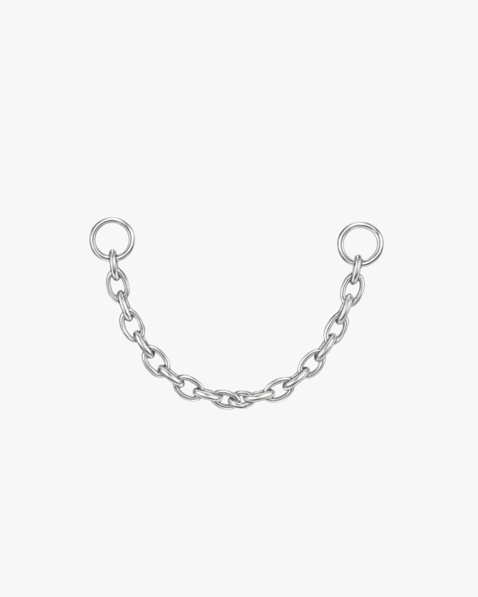 Silver chain with two rings on a white background
