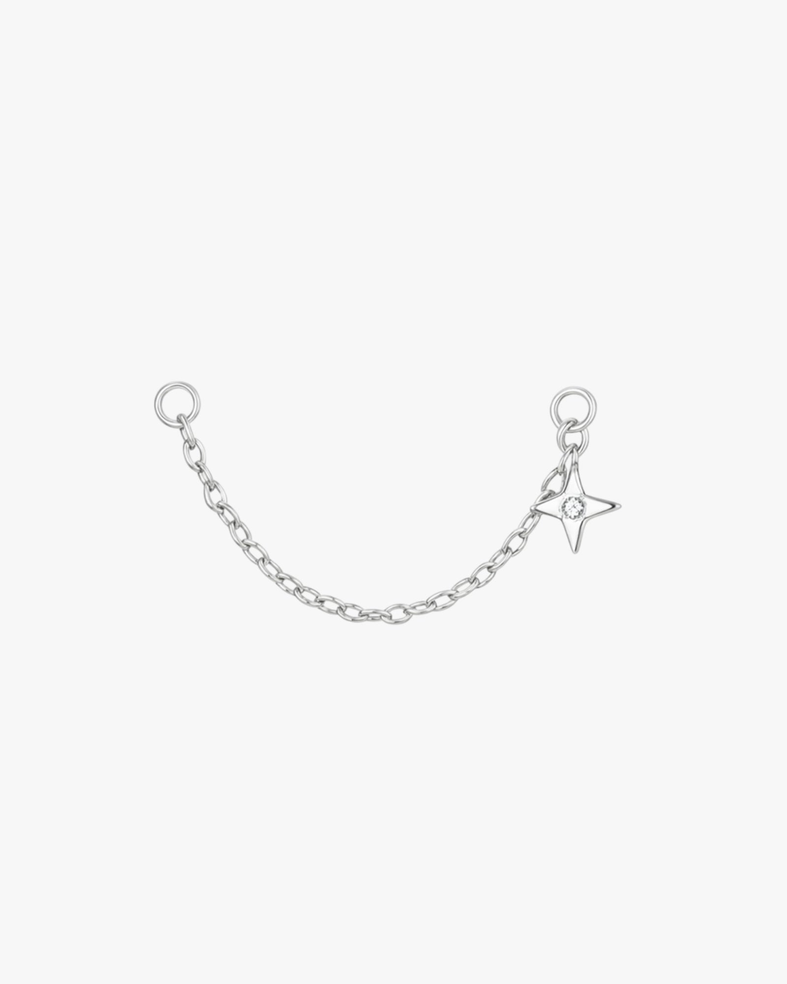 Silver chain with star charm on a white background