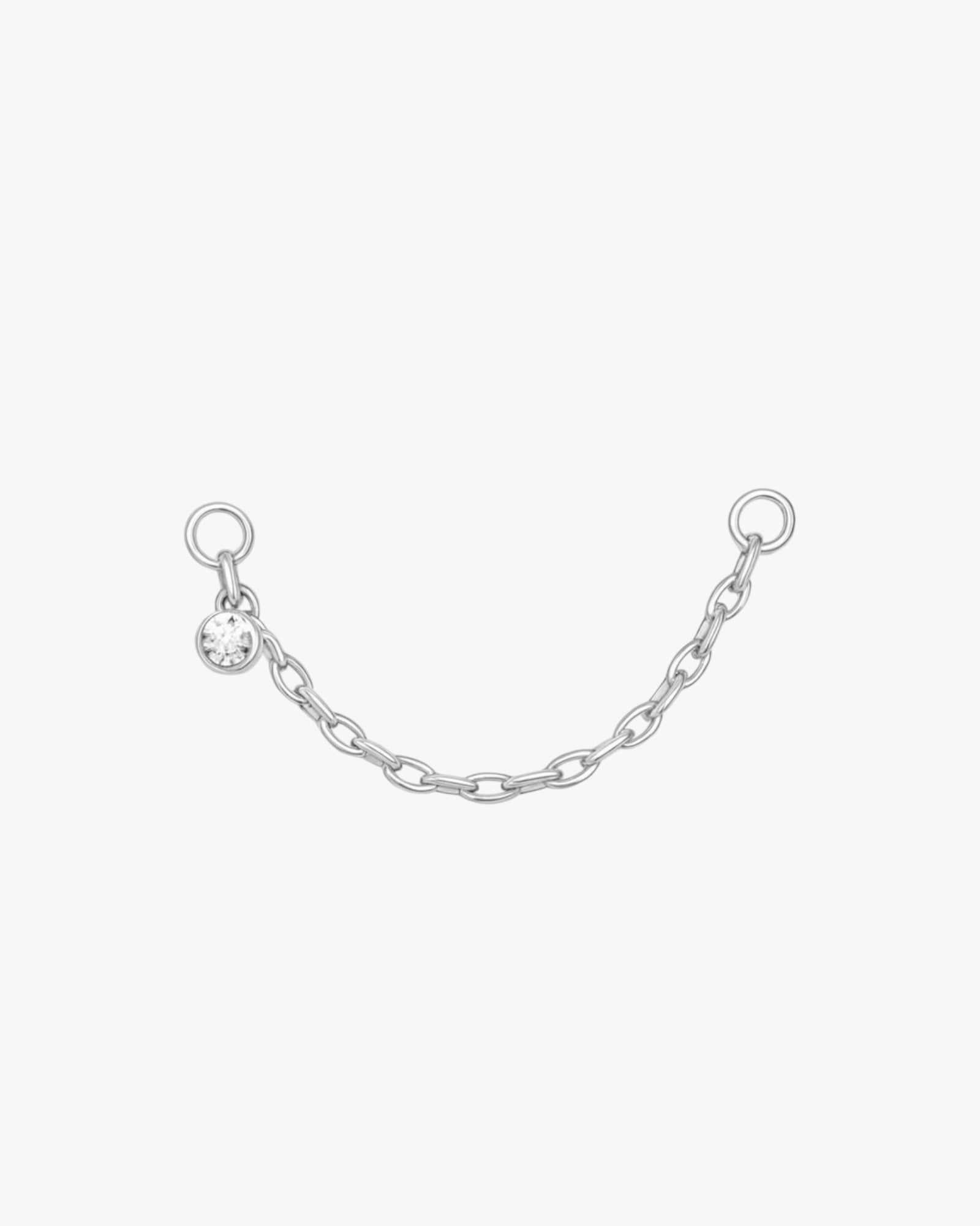 Silver chain with a small round pendant on a white background