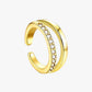 A gold-plated cuff with zirconia stones set along its length.