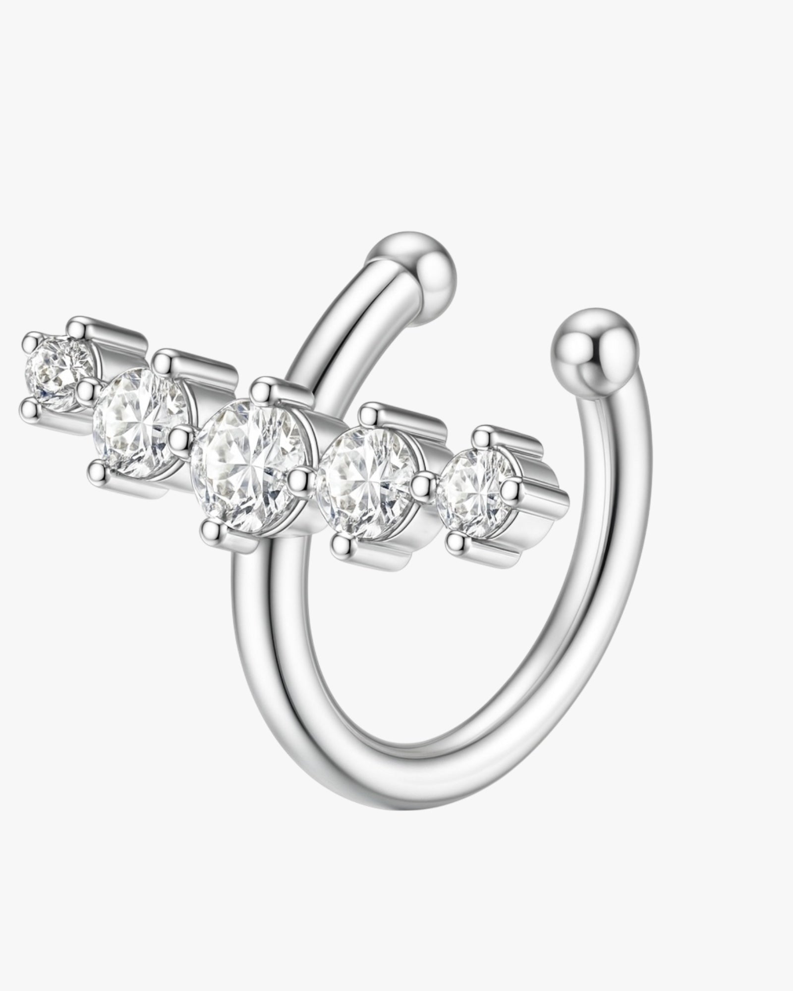 Silver ear cuff with clear gemstones on a white background