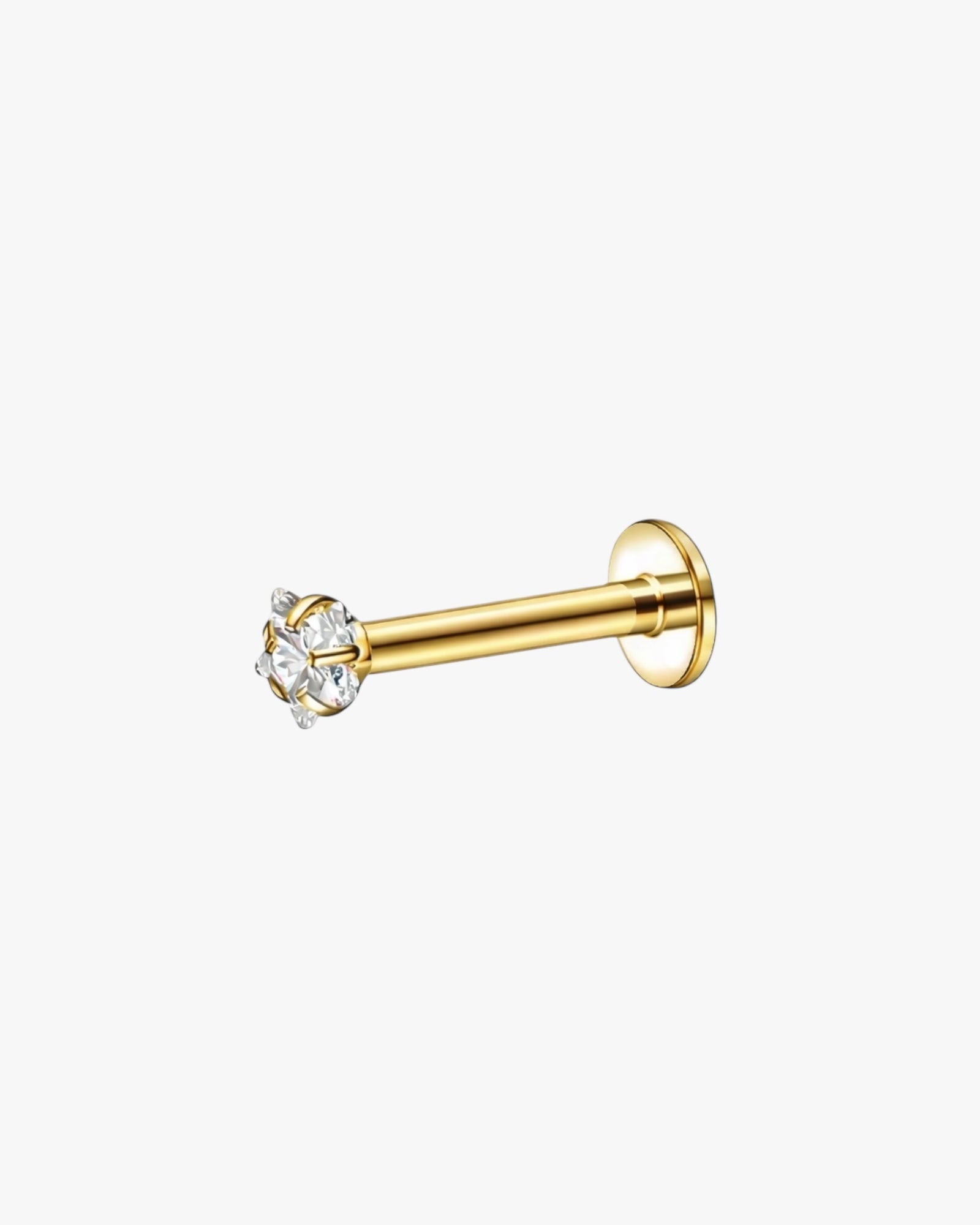 Gold stud with clear gemstones on a white background