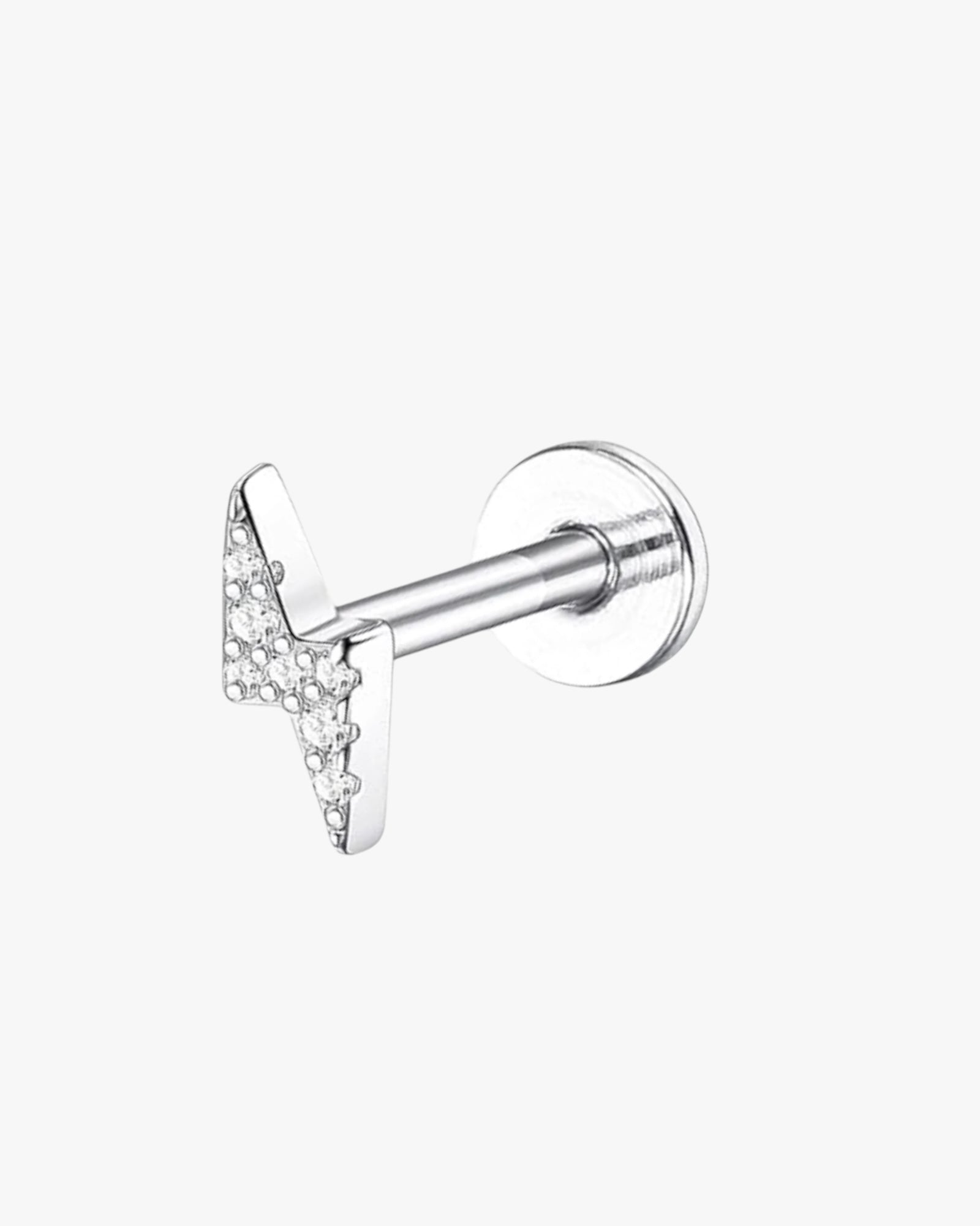 A single silver-colored stud earring with a clear, encrusted with diamonds, top and a textured surface.