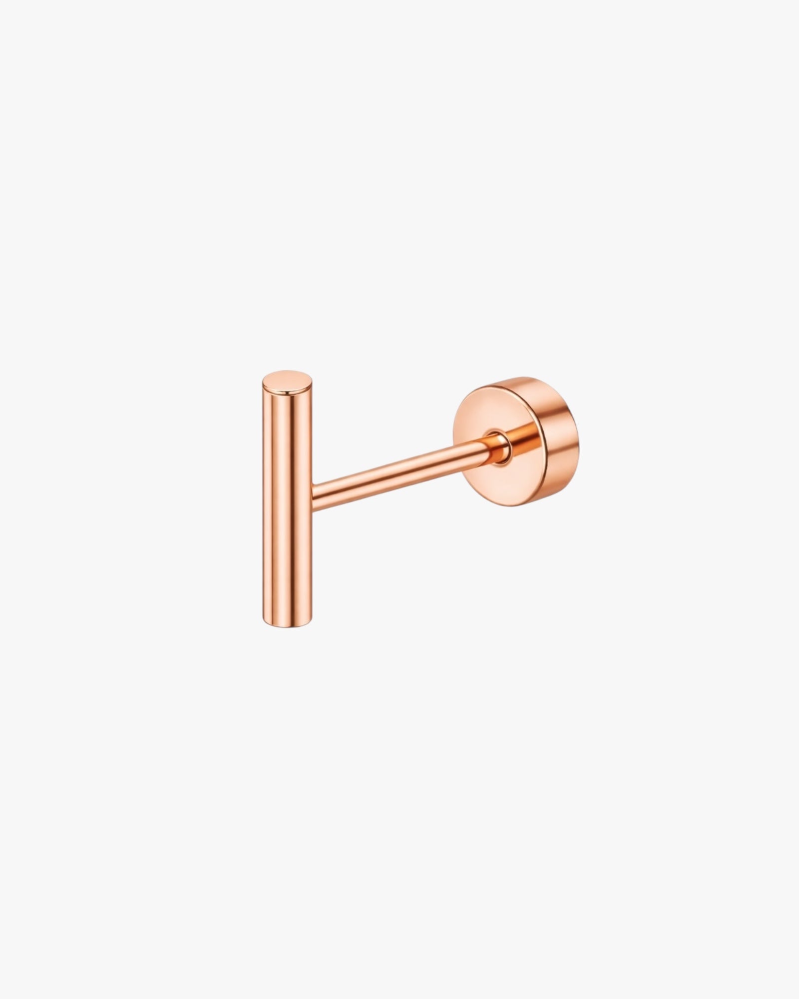 Rose gold ear stud on a white background