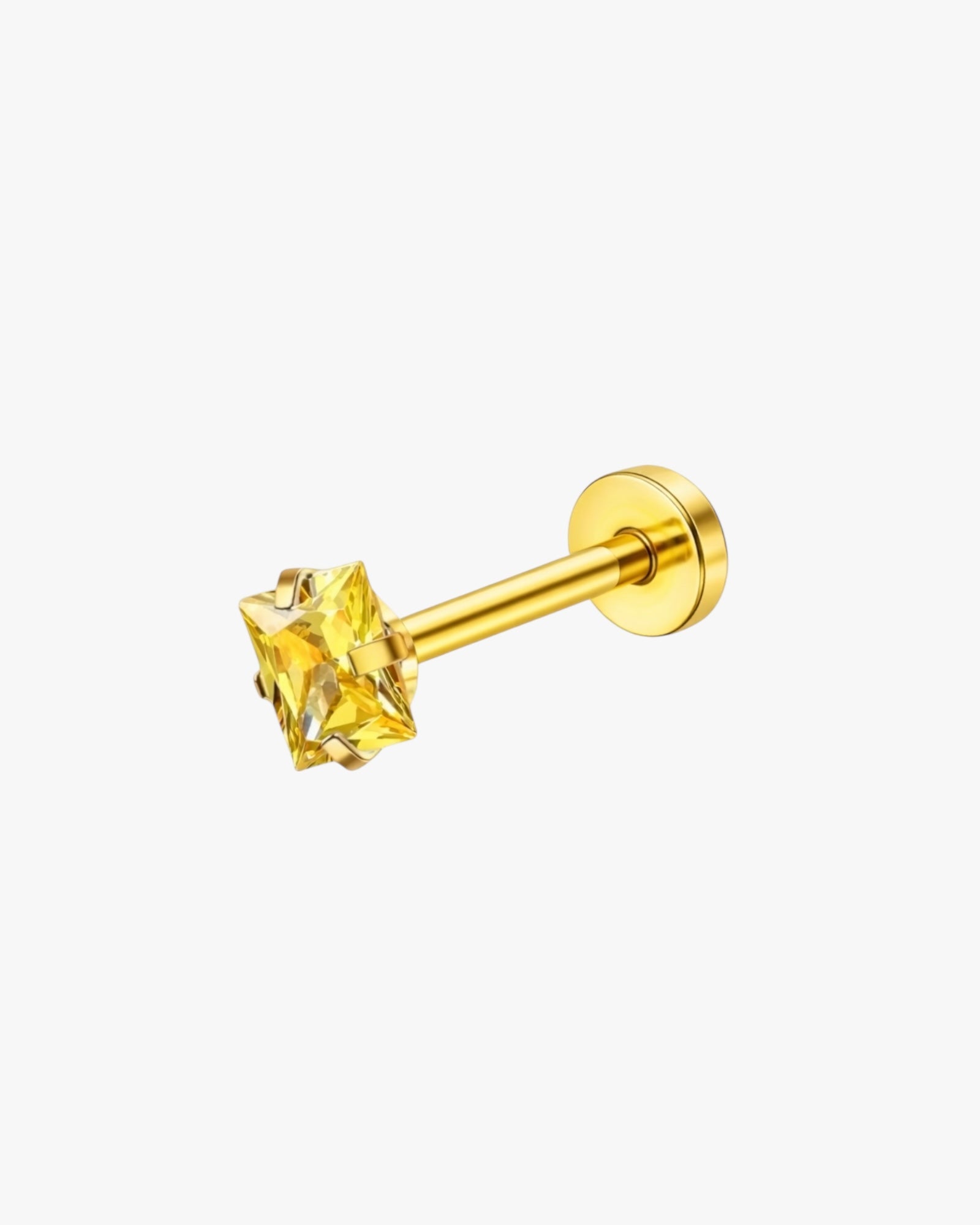 Gold stud earring with a yellow gemstone on a white background