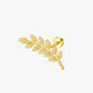 Gold leaf-shaped earring on a white background