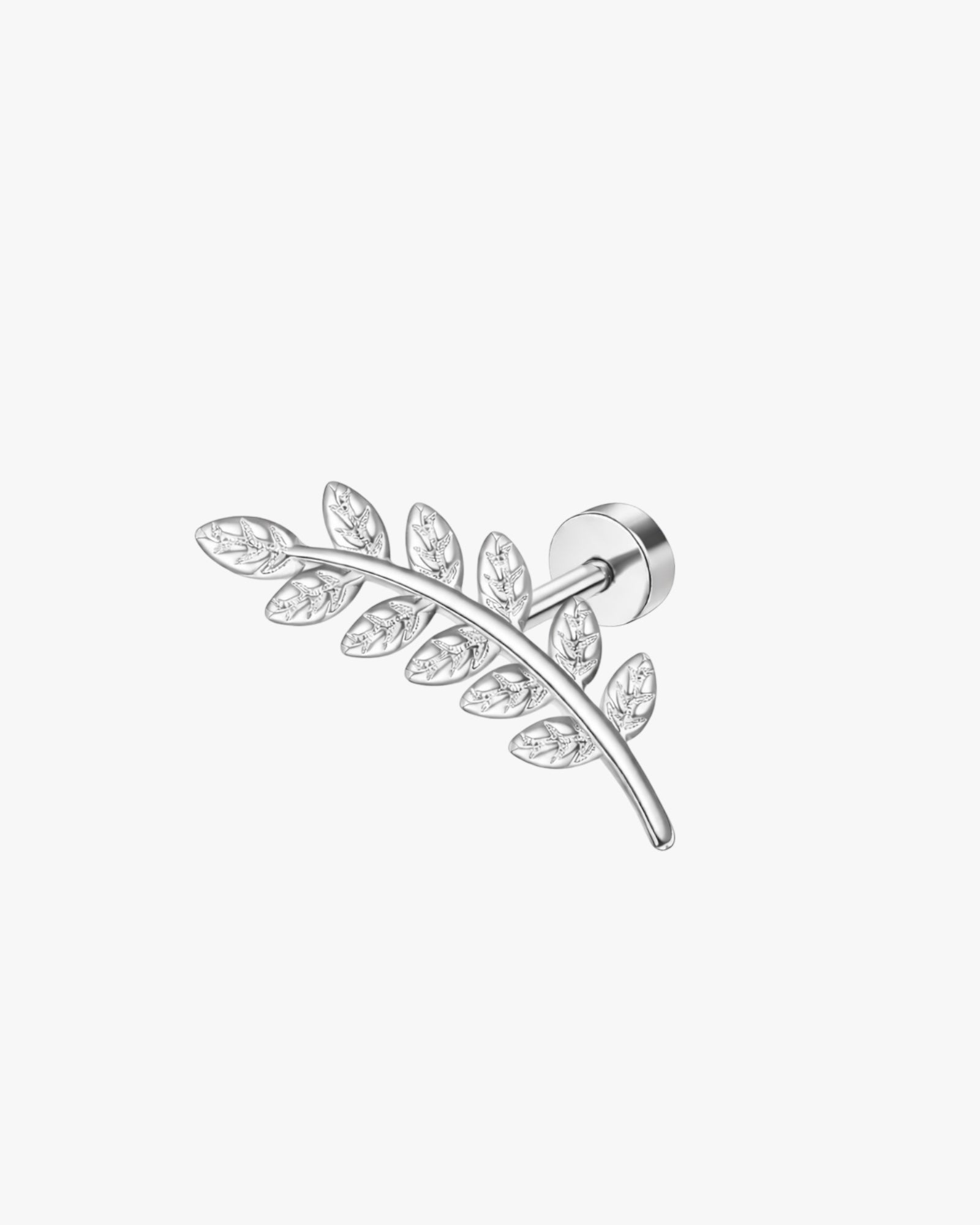 Silver leaf-shaped earring with clear gemstones on a white background