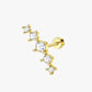 Gold earring with clear gemstones on a white background