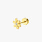 Gold flower-shaped earring on a white background