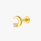 Gold moon-shaped earring with a clear gemstone on a white background