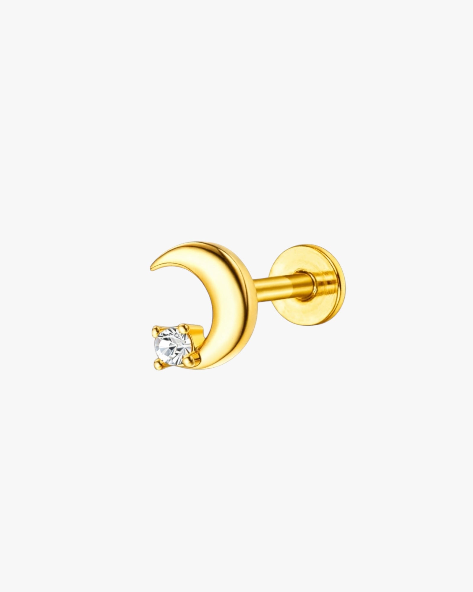 Gold moon-shaped earring with a clear gemstone on a white background