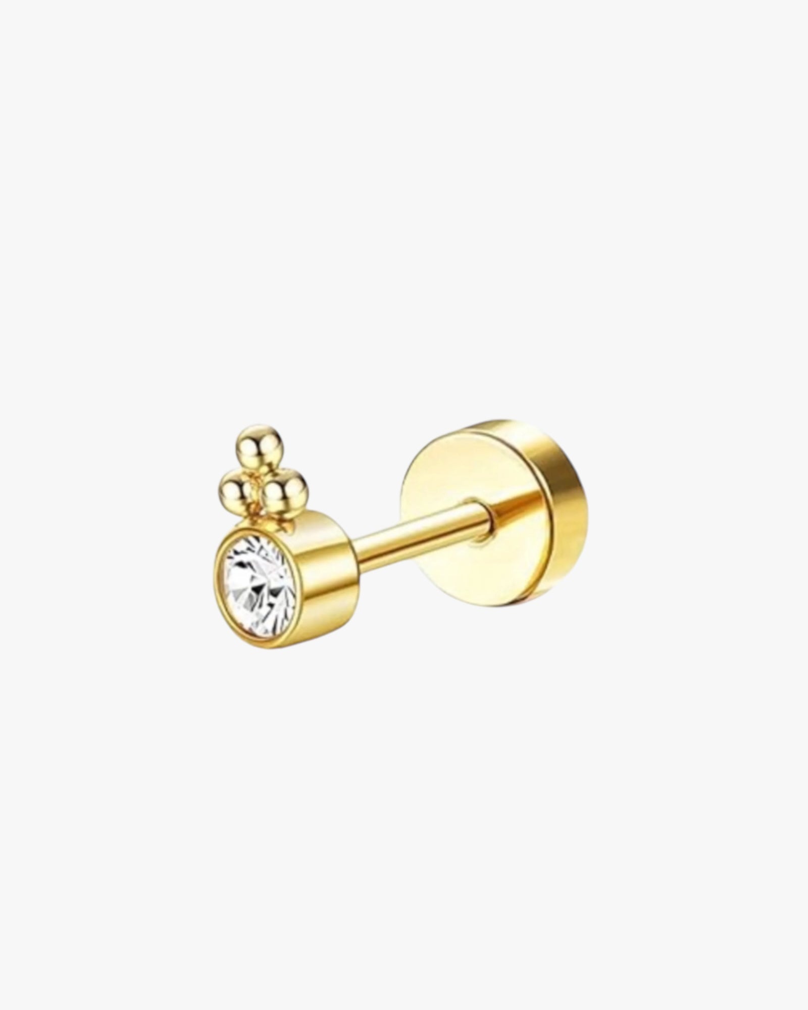 A gold-colored stud earring with a crystal embellishment on a white background.