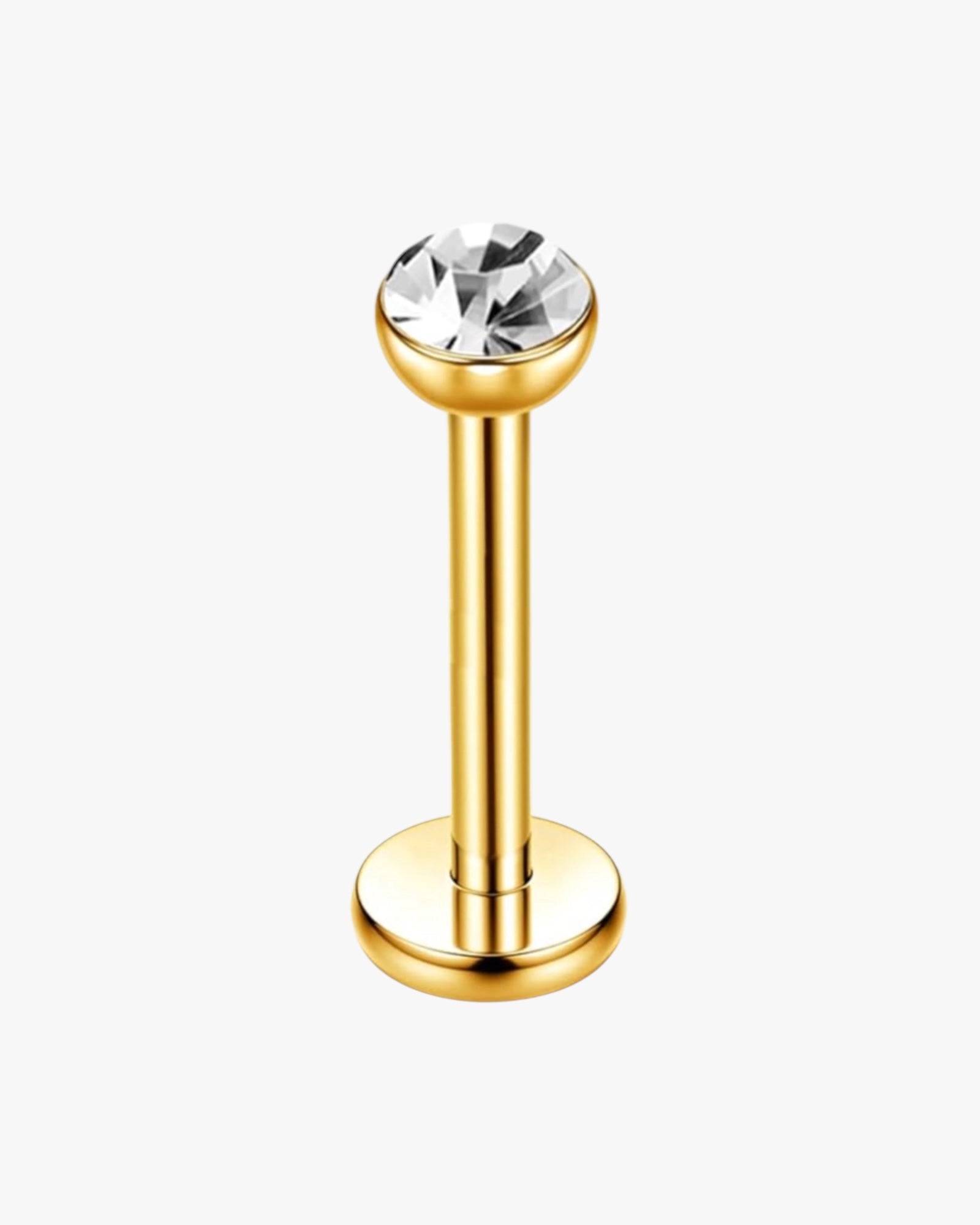A single gold-colored stud earring with a clear, round, titanium bar top.