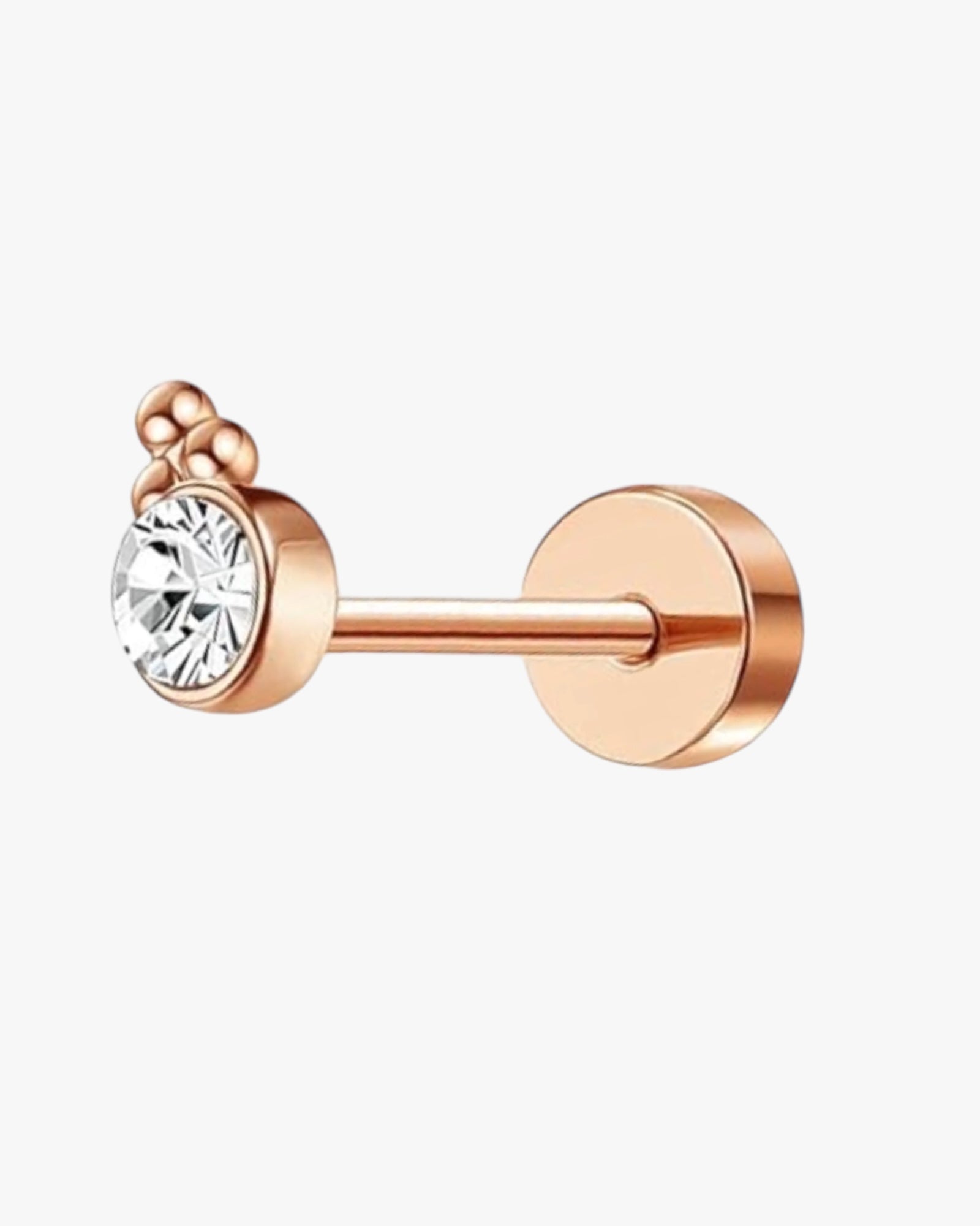 A rose gold stud earring with a central diamond surrounded by smaller clear crystals, set in a gold-colored frame.