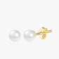 A pair of gold-plated stud earrings with a white pearl-like bead and a yellow gold-plated band.